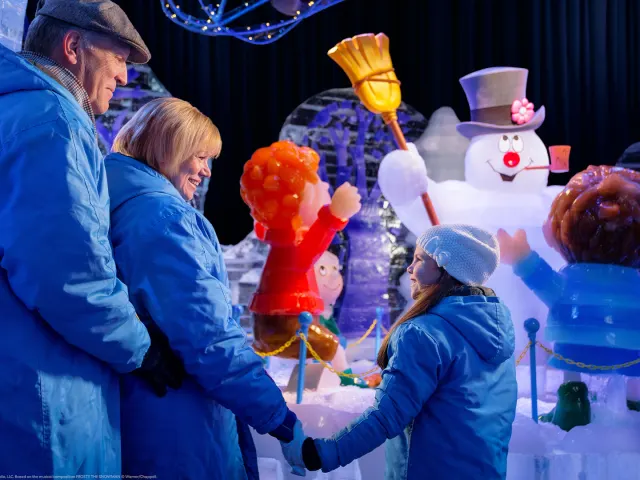 Families looking at Frosty the Snowman exhibit.