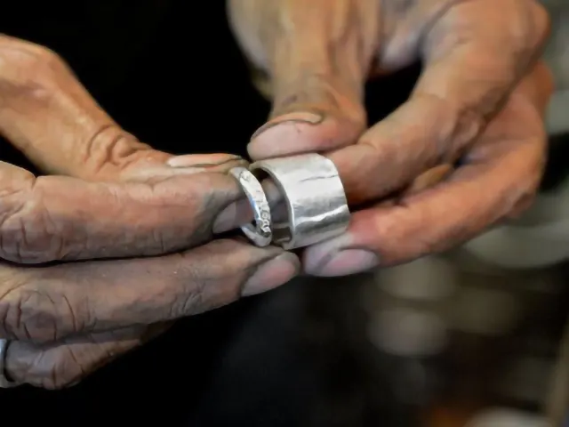 man holding silver ring