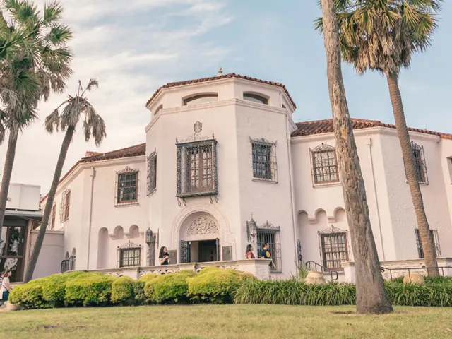 Exterior view of McNay Art Museum with palm trees
