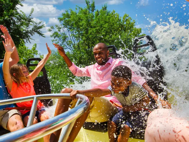 Family on circular ride being splashed
