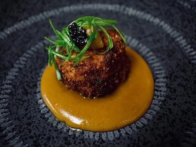 Appetizer surrounded by sauce