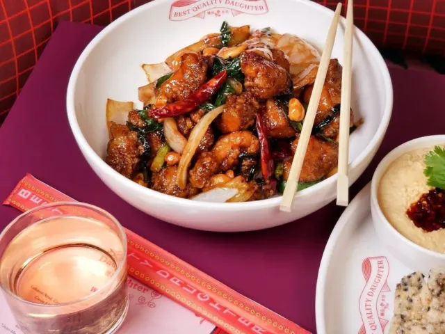 Overhead view of bowl with food inside and chopsticks laid on top.