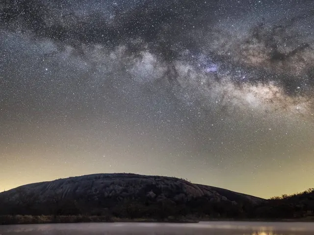 Starry night sky over hills