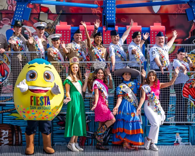 Group of people smiling and posing with costumed cascarone.