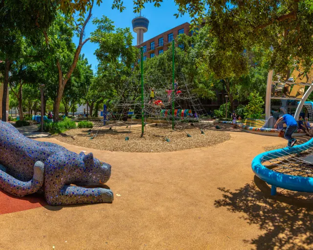 Outdoor play area with Tower of the Americas in the background