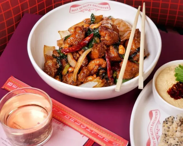 Overhead view of bowl with food inside and chopsticks laid on top.