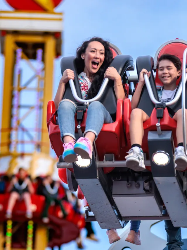 Mother and son laughing on Cyborg ride at Six Flags Fiesta Texas.