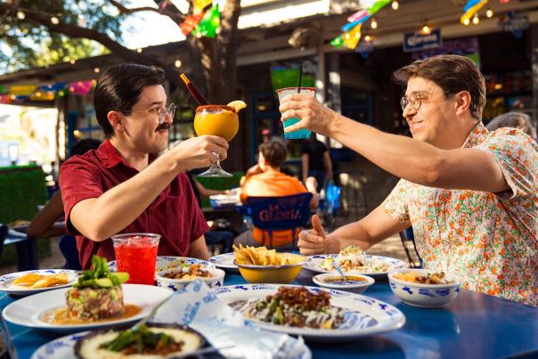 Couple enjoying frozen margaritas and mexican Food
