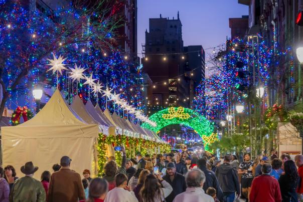 Festive holiday lights above outdoor market