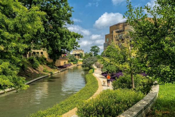 Woman walking dog along Museum Reach of River Walk