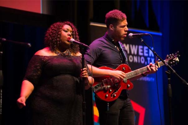 Man playing guitar and woman singing