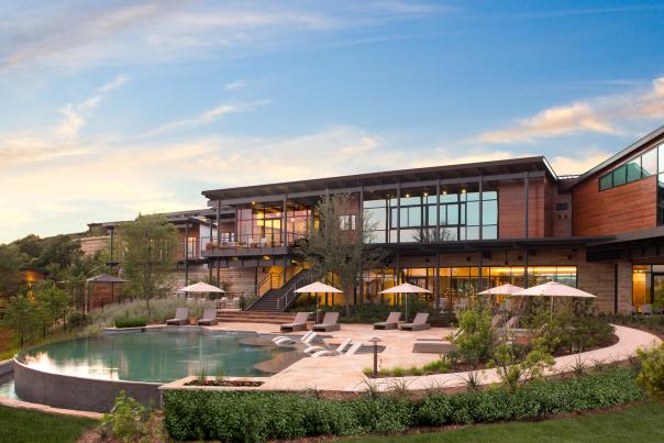 External building overlooking pool with umbrellas