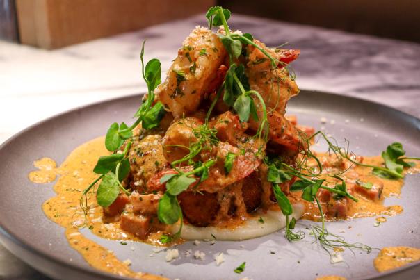 Plated dish with creamy toppings on top of it.