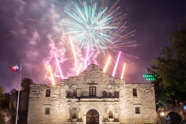Fireworks going off behind the Alamo.