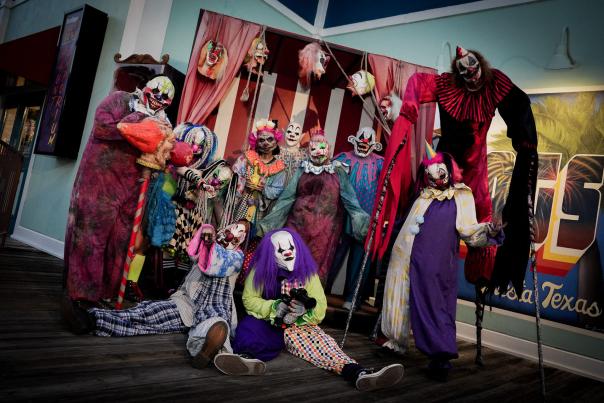 Row of clowns in haunted house at Six Flags Fiesta Texas Fright Fest.