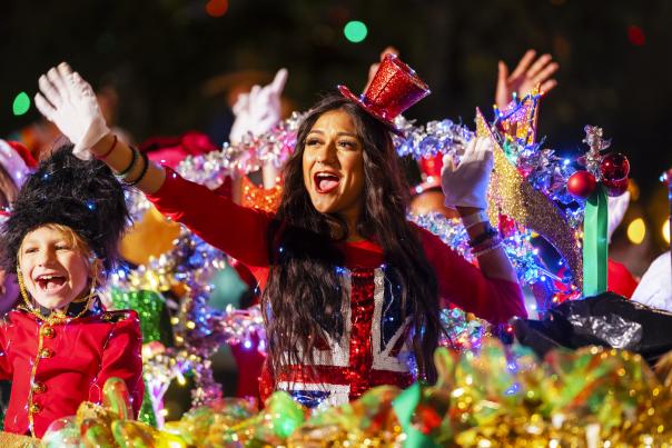 Participants waving from river barge with holiday decorations