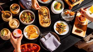 Overhead view of spread of food at Tenfold bar at Kimpton Santo in San Antonio.
