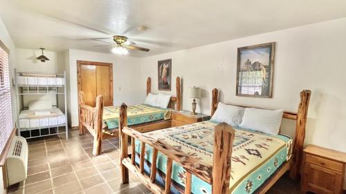 Bedroom at Rancho Cortez with a western theme and a bed with wooden frames.