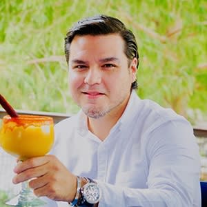 man posing holding a cocktail
