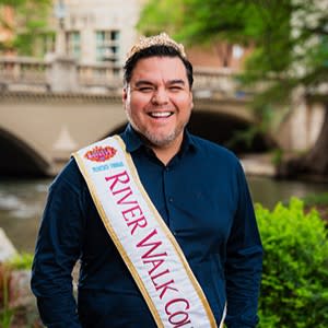 man posing on River Walk with royalty Count sash