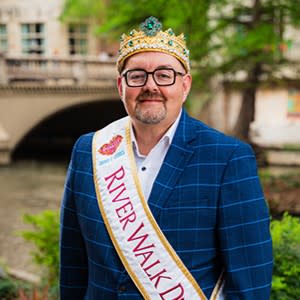man posing on river walk with royalty Duke sash