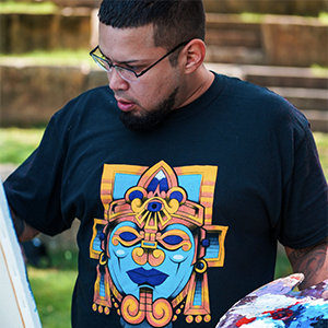 Artist Marcos Vargas painting outside
