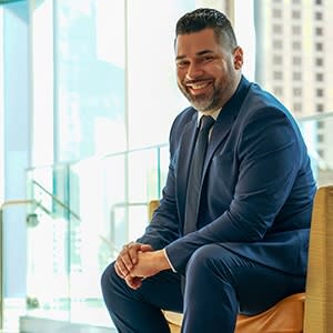 man posing in navy suit