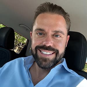 man posing for photo in car