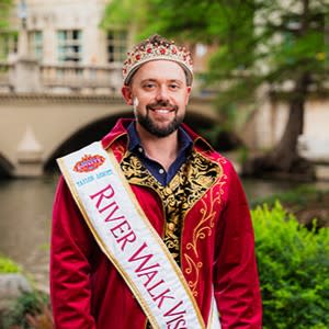 man posing for photo on the river walk with viscountess sash