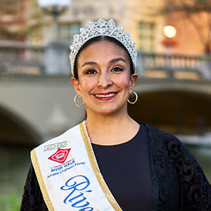 woman taking photo in front of river walk