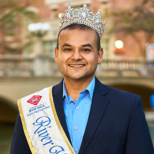man having photo taken in front of river walk