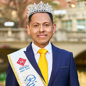 Man having photo taken in front of river walk