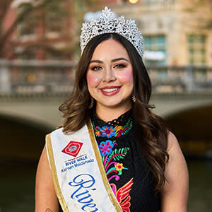 Woman standing in front of river walk