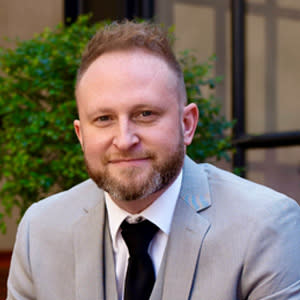 Professional headshot of man with tie