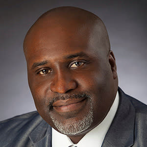 Professional headshot of man in business suit