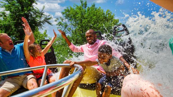 Family on circular ride being splashed