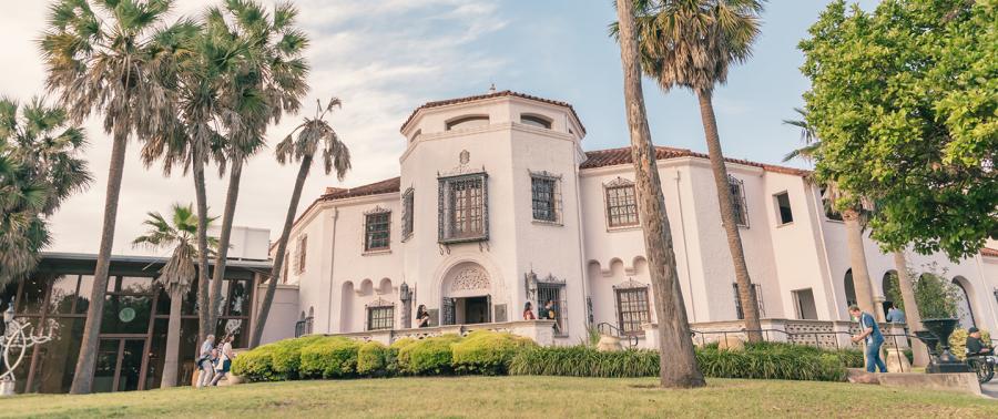 Exterior view of McNay Art Museum with palm trees