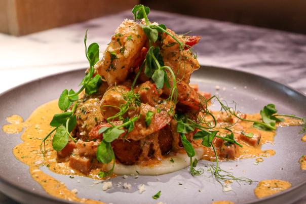 Plated dish with creamy toppings on top of it.