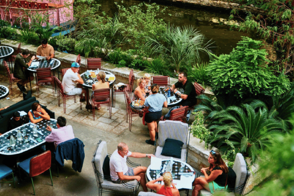 guests dining on a patio by the River Walk