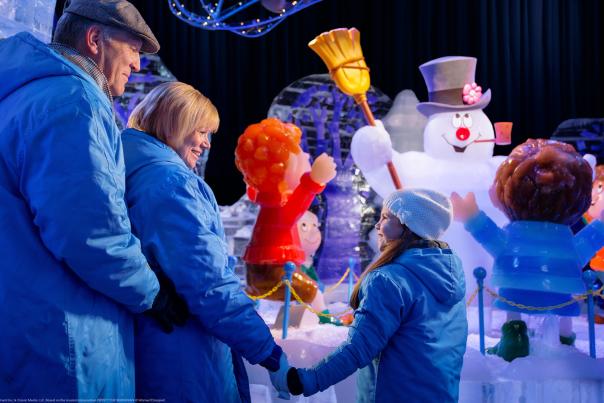 Families looking at Frosty the Snowman exhibit.