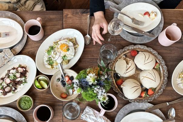 food spread out on a table with brunch food
