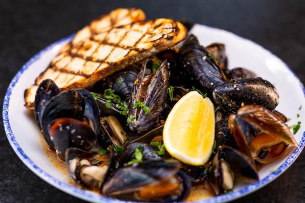 Bowl of seafood with side bread