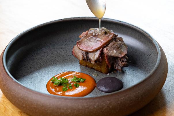 Spoon drizzling glaze over meal.