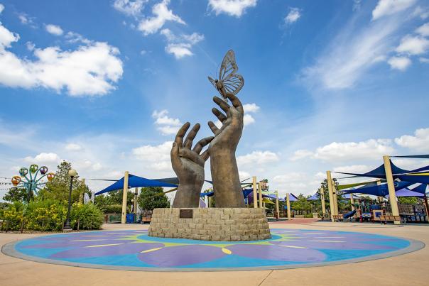 Sculpture of hands with butterfly landing on them