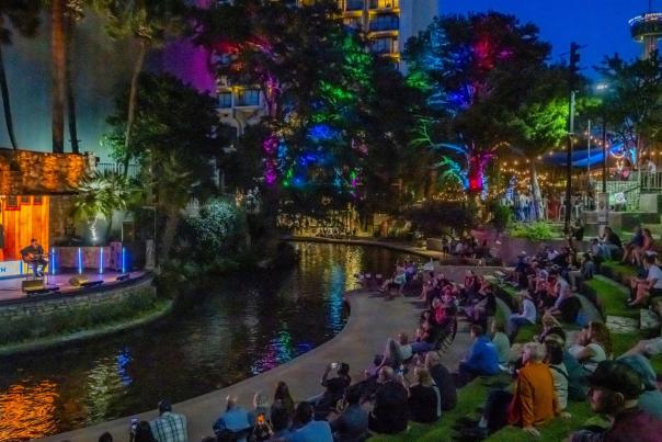 People on lawn enjoying concert