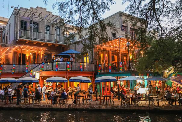 People dining along the San Antonio River Walk.