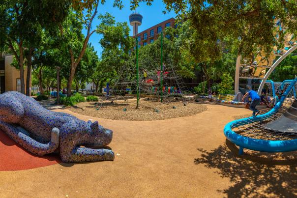 Outdoor play area with Tower of the Americas in the background