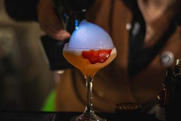 Beverage being poured with overflowing bubble