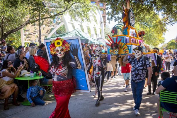 Procession with people dressed in sugar skull attire