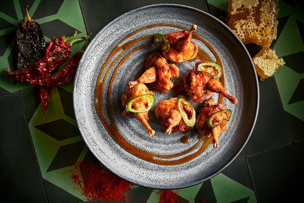 Overhead view of chicken wings on circular plate.